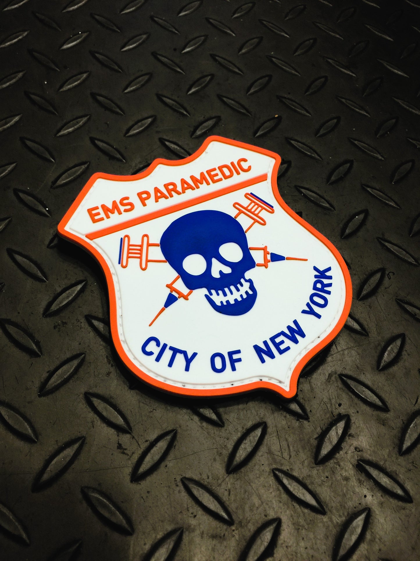 NYC EMS Paramedic Velcro PVC patch on a gray grid iron background.