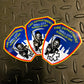 FDNY Bureau Of EMS patch reflective stickers from skell city, in a fan formation against a gray gridiron background.