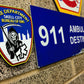 EMS patch from skell city, up against FDNY logo ER bay plaque.