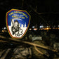 FDNY EMS patch from skell city, sitting on a branch inside of graveyard.