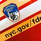 EMS patch from skell city on the side of an FDNY ambulance with web page address.