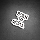 Skell City Born to skell clear sticker up against black concrete background.